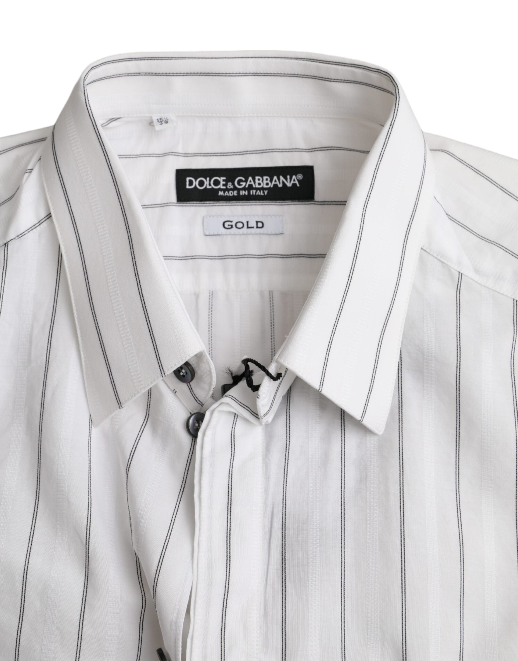 Black and white striped formal dress with gold accents by Dolce & Gabbana, displayed on a dress form.