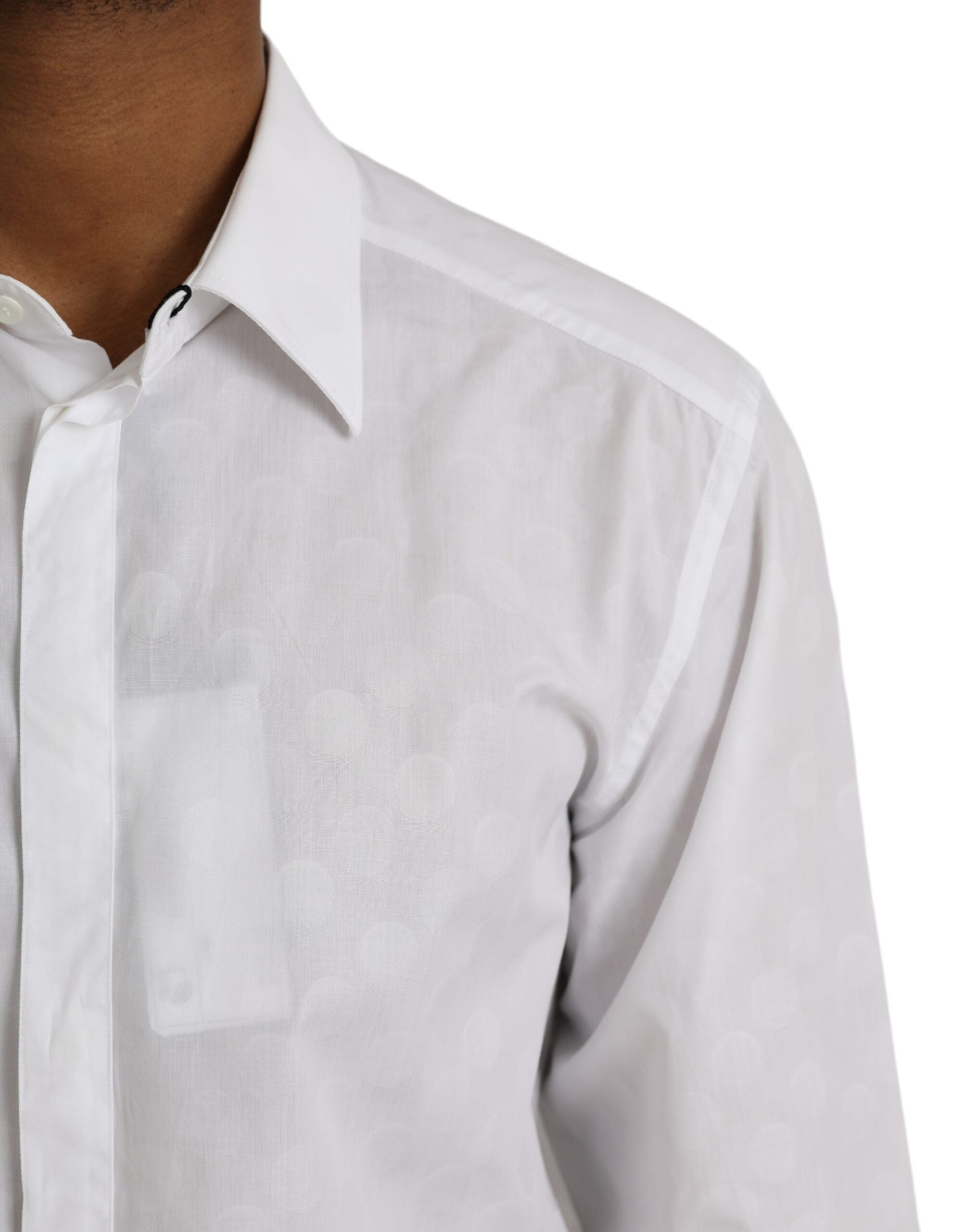 White cotton dress with black polka dots and gold accents from Dolce & Gabbana, shown on a hanger against a plain background.