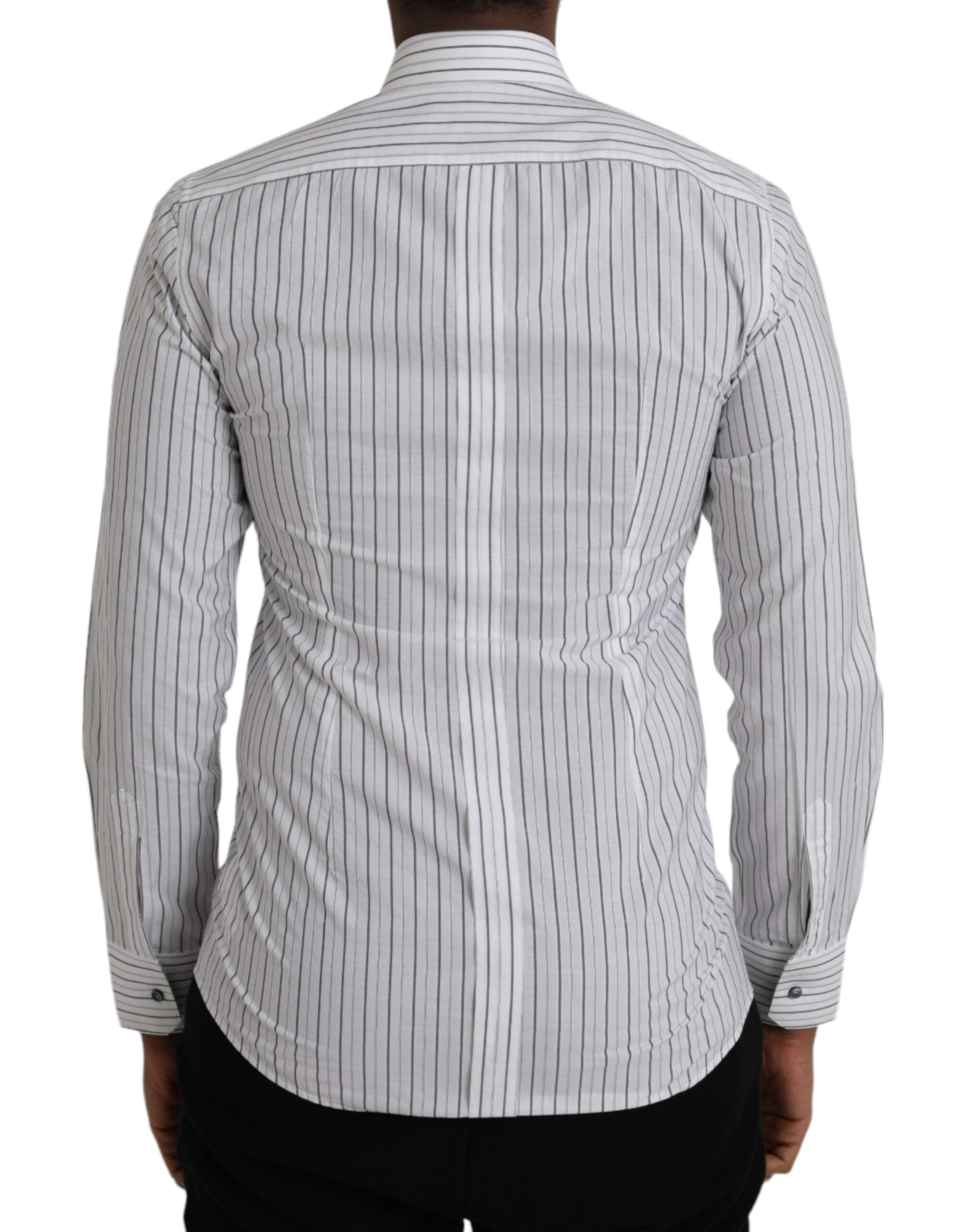 Black and white striped formal dress with gold shirt detail by Dolce & Gabbana, shown on a mannequin.