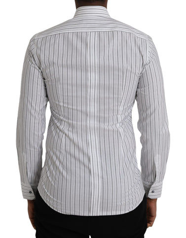 Black and white striped formal dress with gold shirt detail by Dolce & Gabbana, shown on a mannequin.
