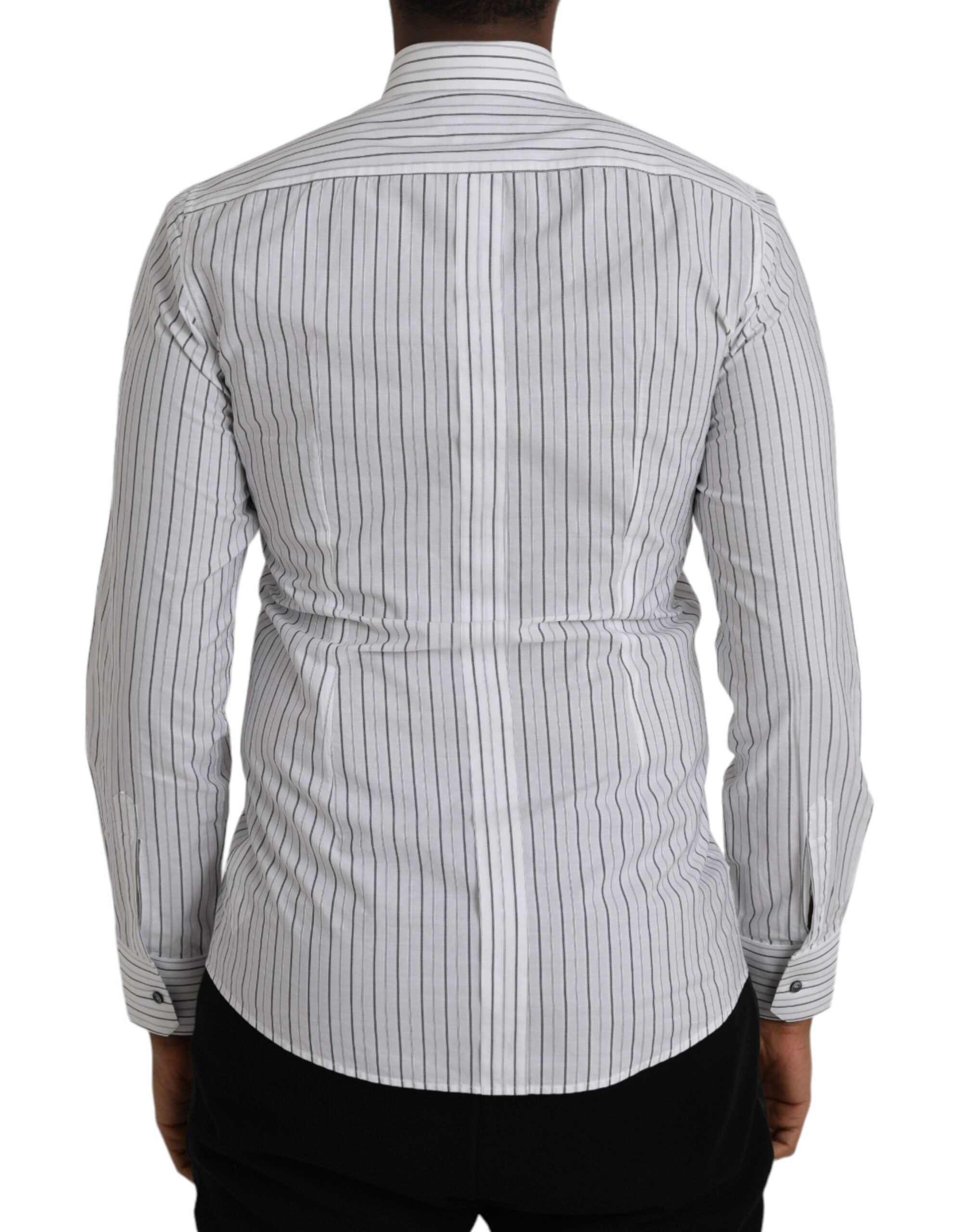 Black and white striped formal dress with gold shirt detail by Dolce & Gabbana, shown on a model.