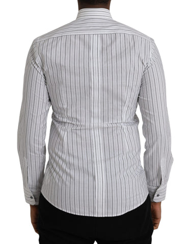 Black and white striped formal dress with gold shirt detail by Dolce & Gabbana, shown on a model.