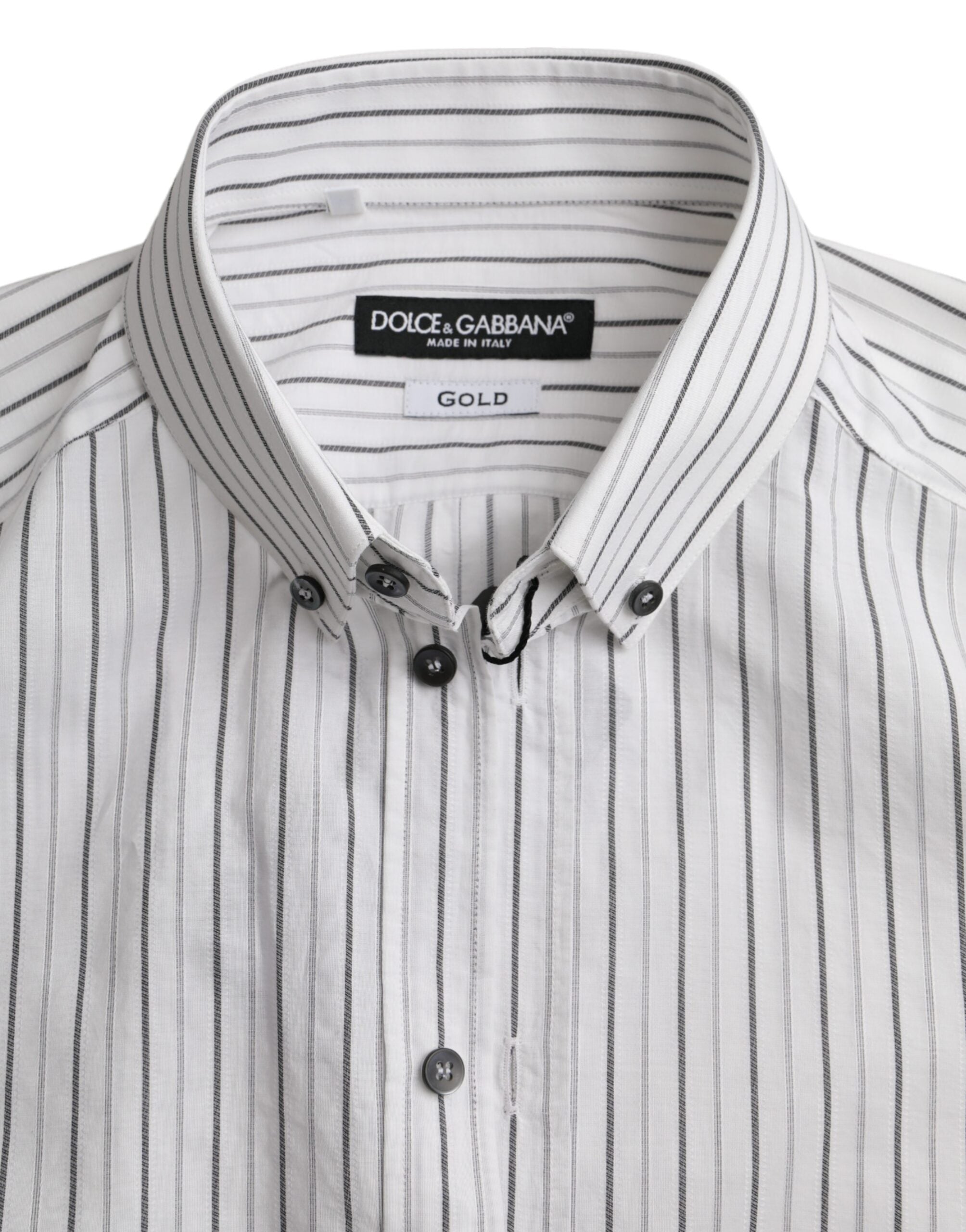 Black and white striped formal dress with a gold shirt detail, designed by Dolce & Gabbana, shown on a model.
