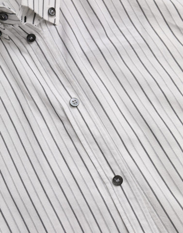 Black and white striped formal dress with gold shirt accents, designed by Dolce & Gabbana, shown on a model.