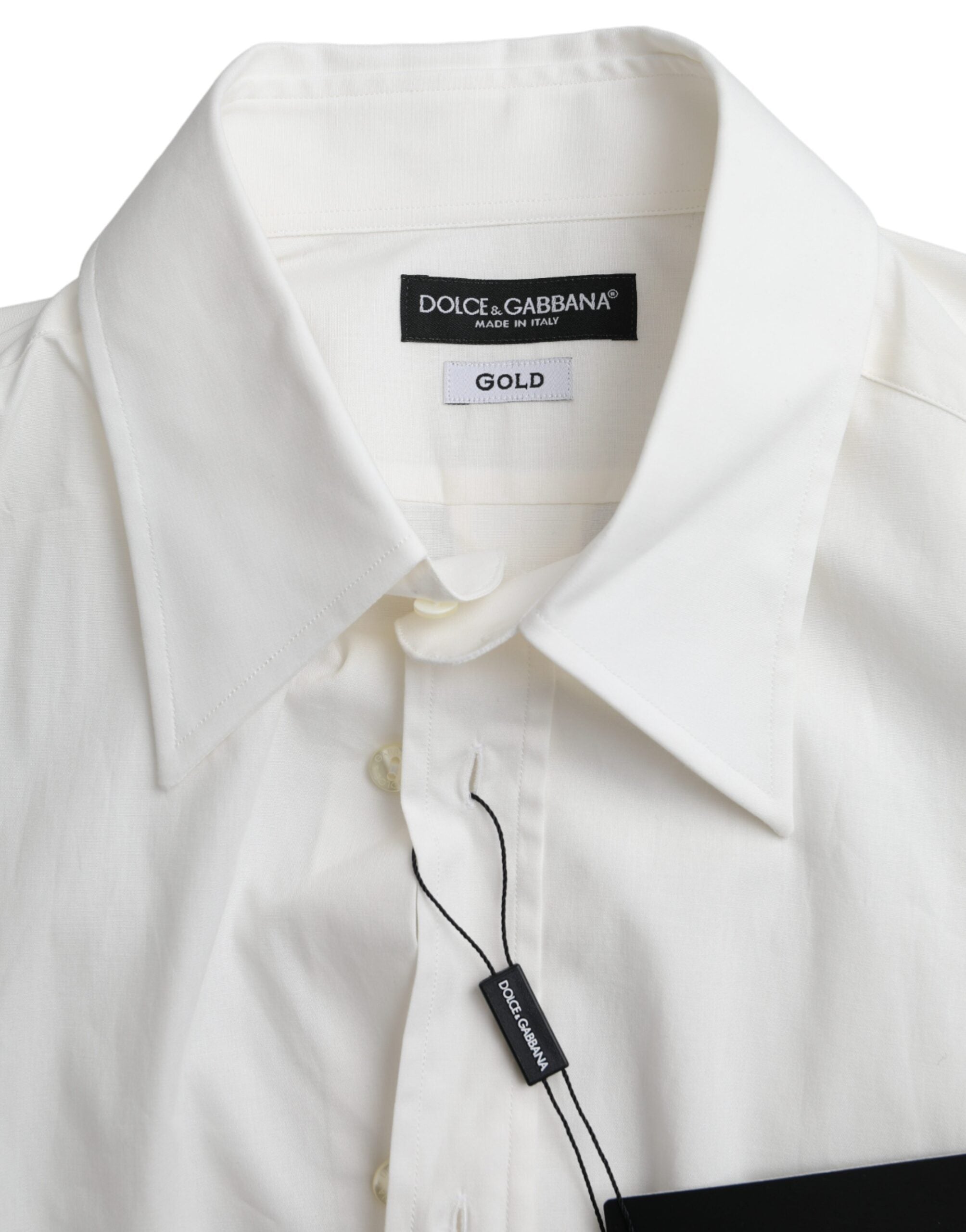 White cotton slim fit dress shirt by Dolce & Gabbana with gold accents, shown on a hanger.