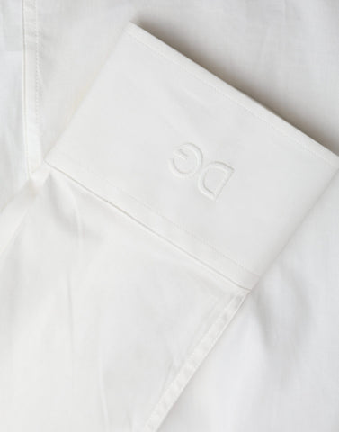 White cotton slim fit dress shirt by Dolce & Gabbana featuring a classic collar and gold accents.
