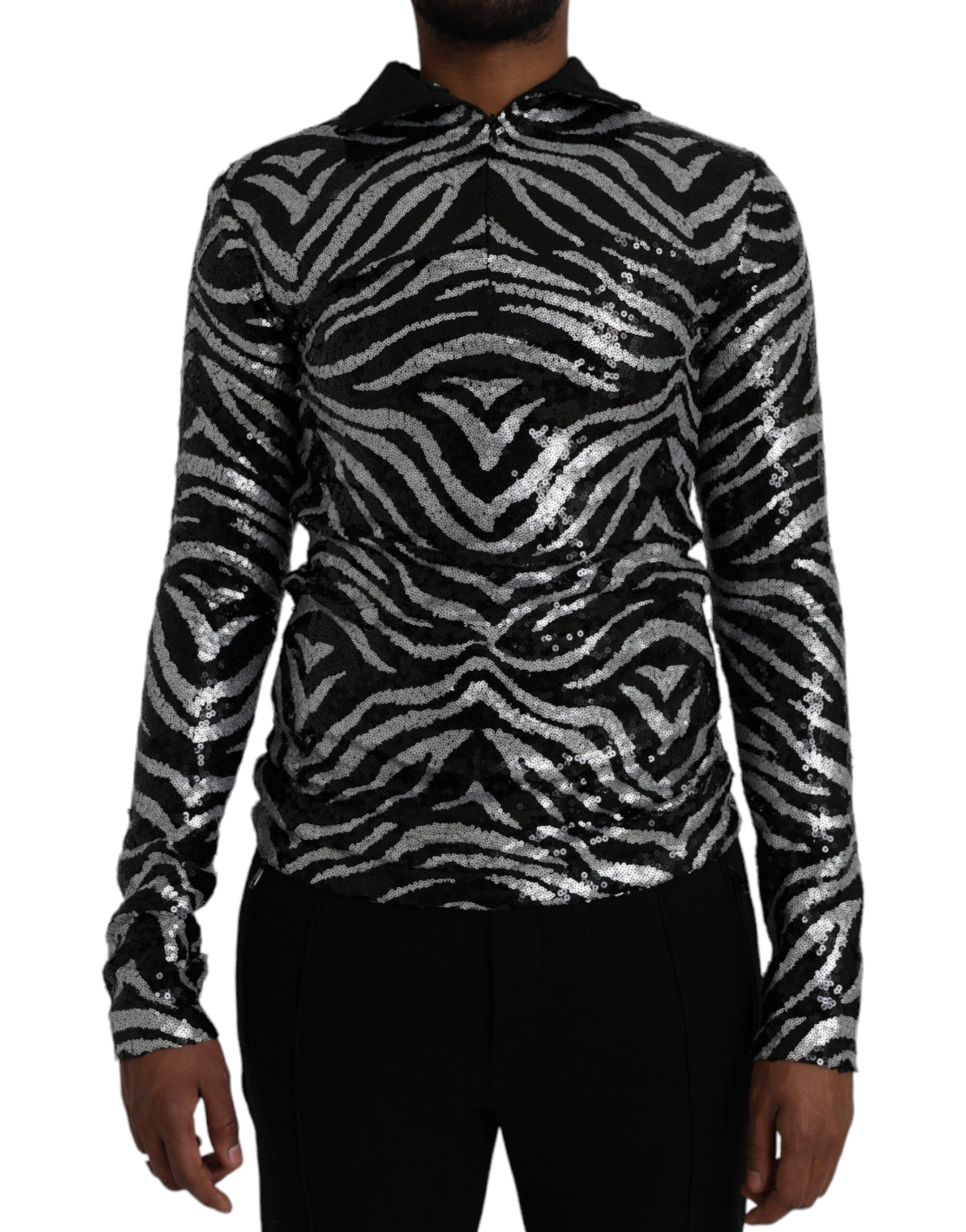 Black silver sequined polyester sweater by Dolce & Gabbana showing a close-up of sparkling sequined fabric and sweater neckline.