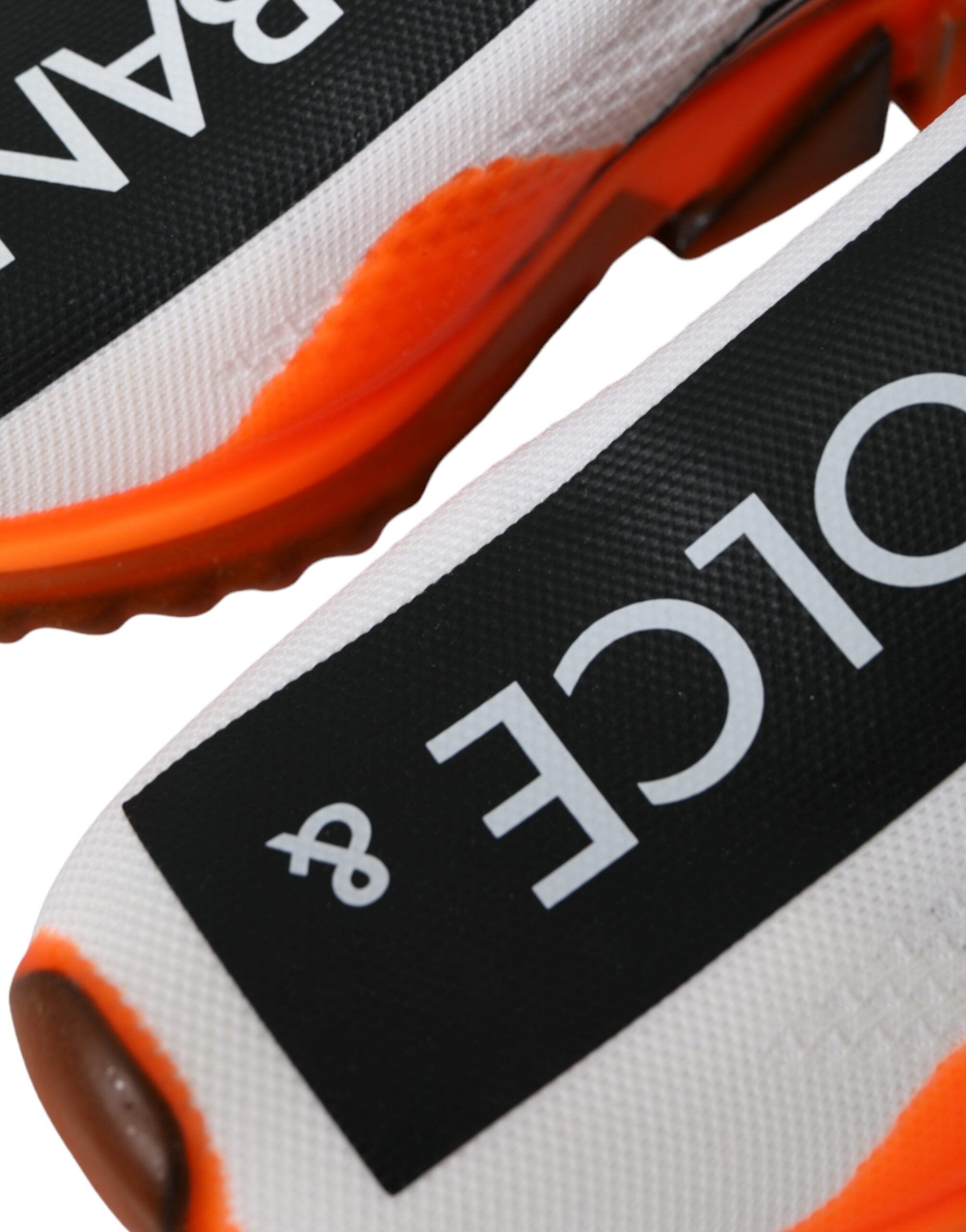 Dolce & Gabbana black, white, and orange slip-on Sorrento sneakers shoes displayed on a white background.