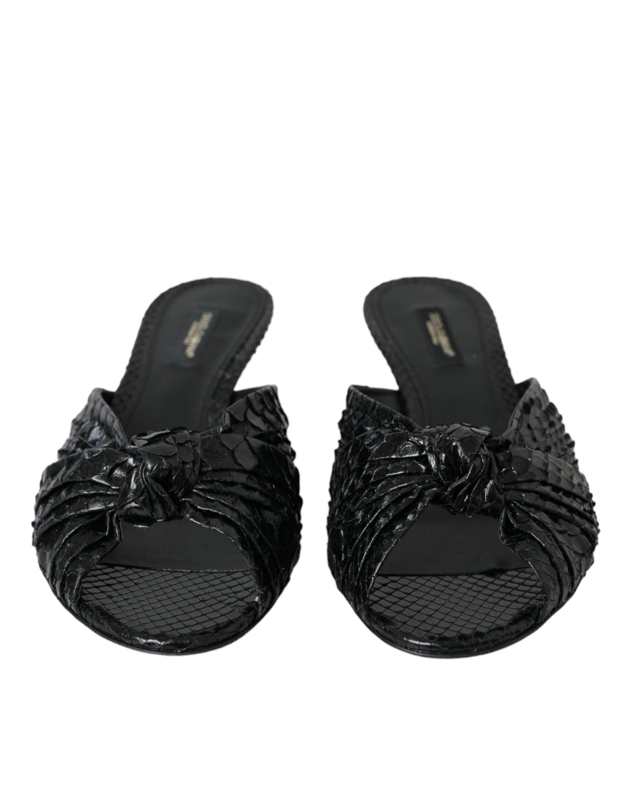 Black exotic leather slides shoes with open toe and slip-on design by Dolce & Gabbana.