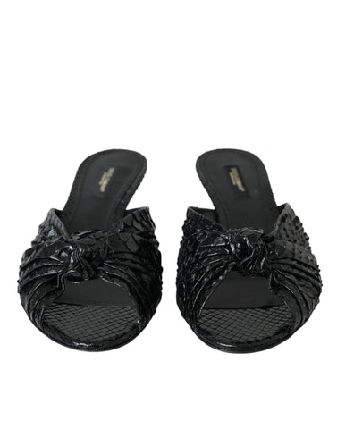Black exotic leather slides shoes with open toe and slip-on design by Dolce & Gabbana.