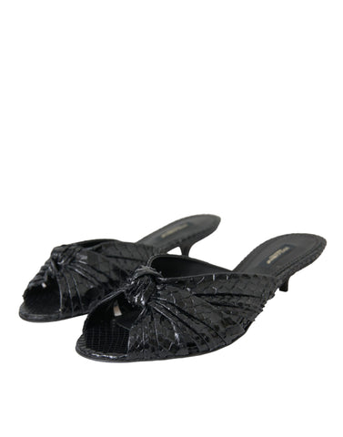 Black exotic leather slide heels by Dolce & Gabbana featuring sleek design and open toe style.