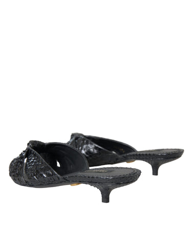 Black exotic leather slide sandals with open toes and chunky heels by Dolce & Gabbana, featuring bold, textured leather straps.