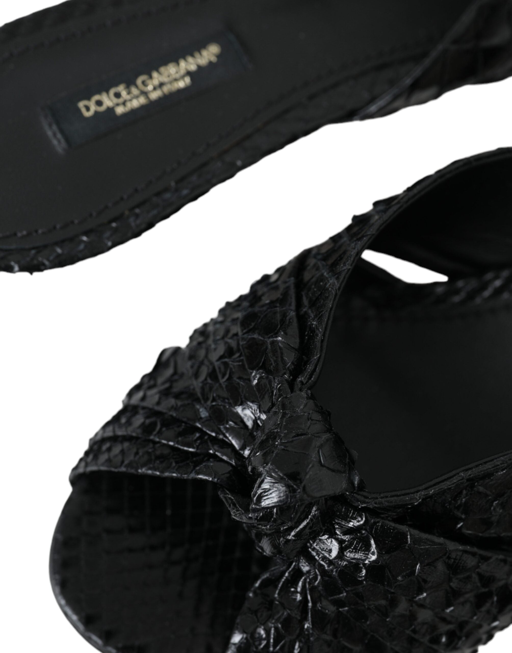 Black exotic leather slide shoes with open toes and chunky heels, designed by Dolce & Gabbana.