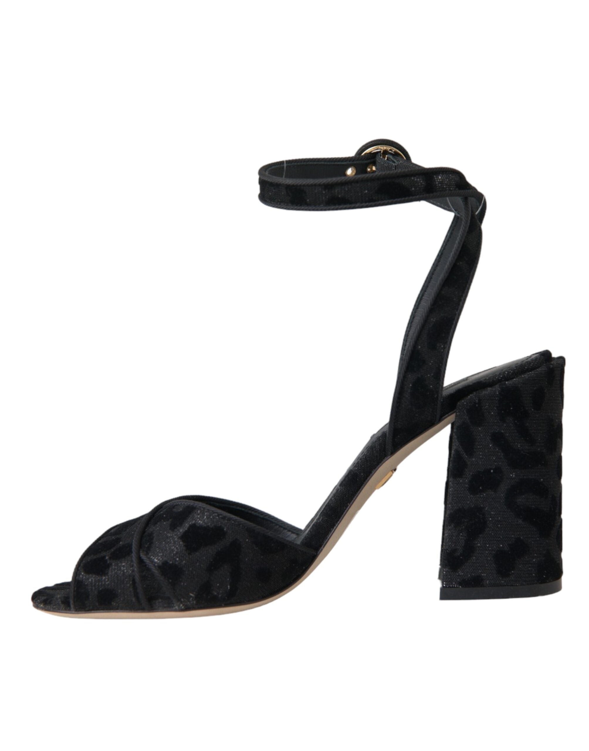 Dolce & Gabbana black leopard suede heels sandals with open toes and ankle straps on a white background.