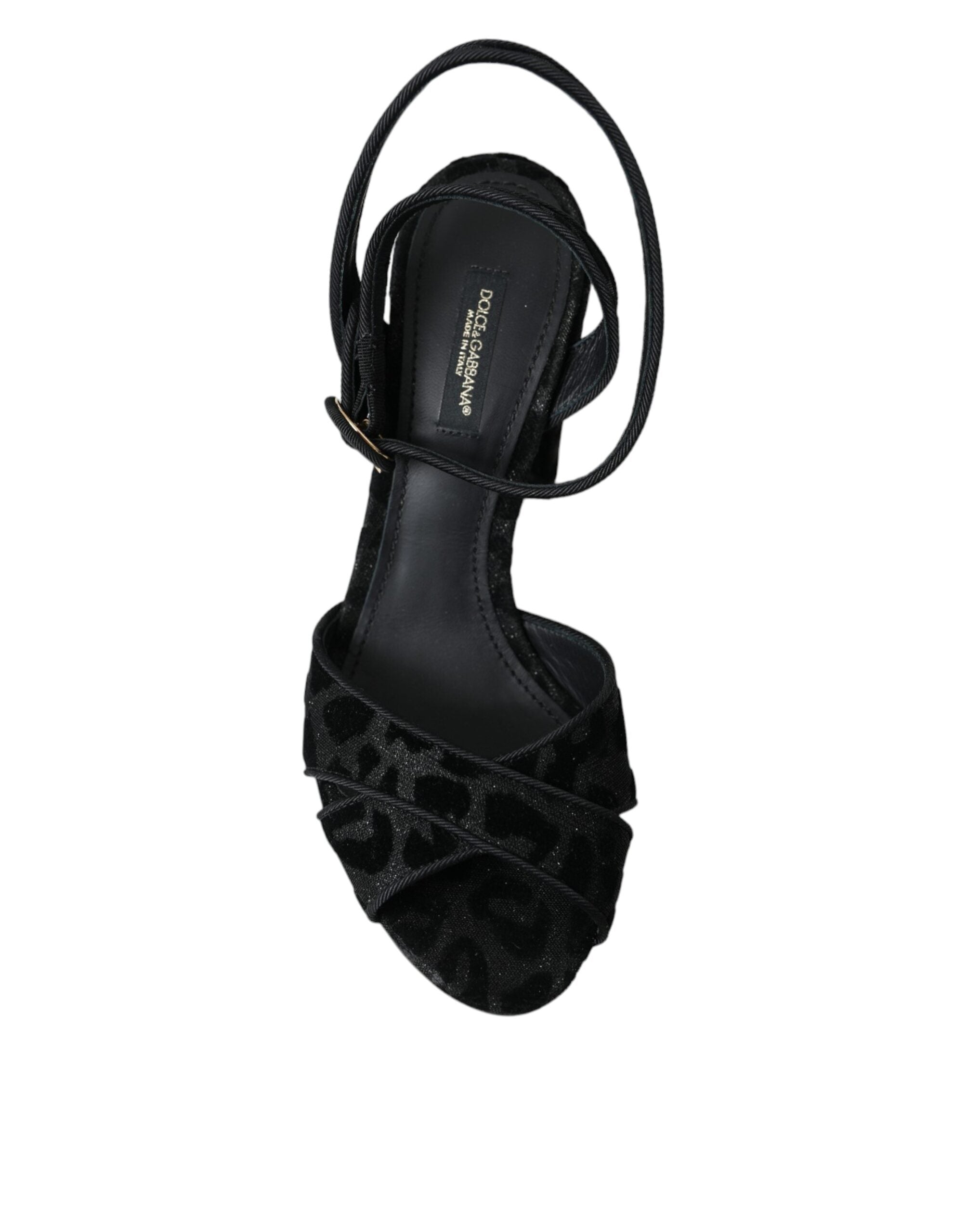 Black leopard print suede heels sandals by Dolce & Gabbana with open toes and ankle straps on a neutral background.