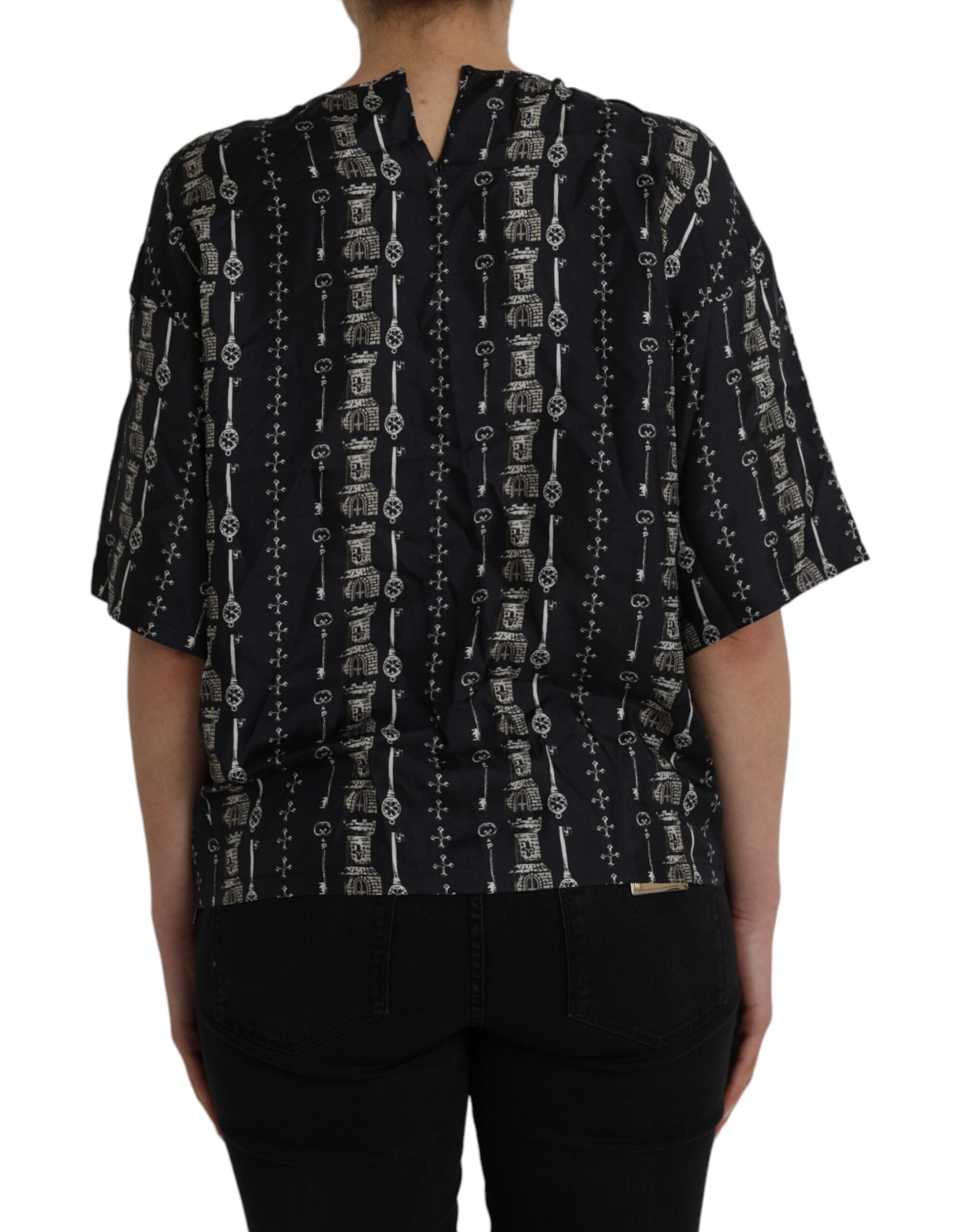 Black silk blouse with castle print and key design, Dolce & Gabbana T-shirt showcasing elegant, detailed fashion craftsmanship.