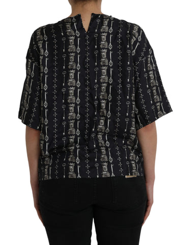 Black silk blouse with castle print and key design, Dolce & Gabbana T-shirt showcasing elegant, detailed fashion craftsmanship.