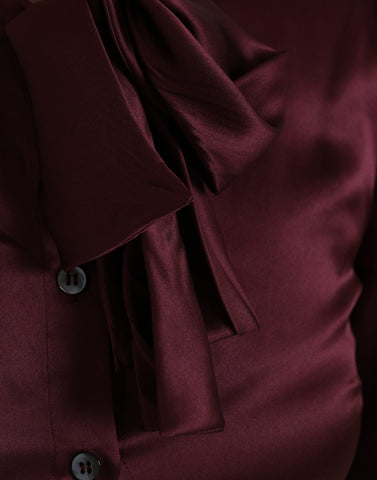 Maroon Dolce & Gabbana long sleeve blouse with ascot collar, stylish and elegant top with a sophisticated design.