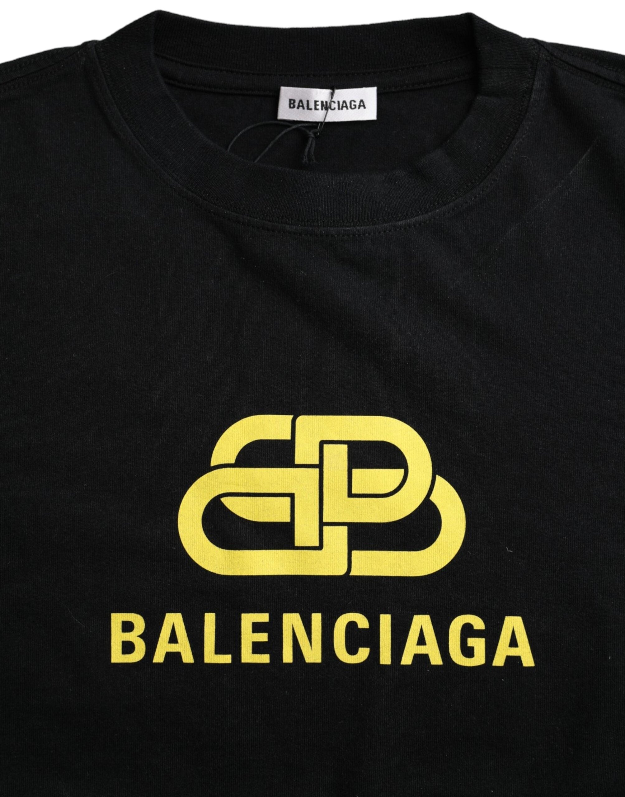 Balenciaga black cotton crew neck T-shirt with logo print, short sleeves and casual fit, displayed on a hanger.