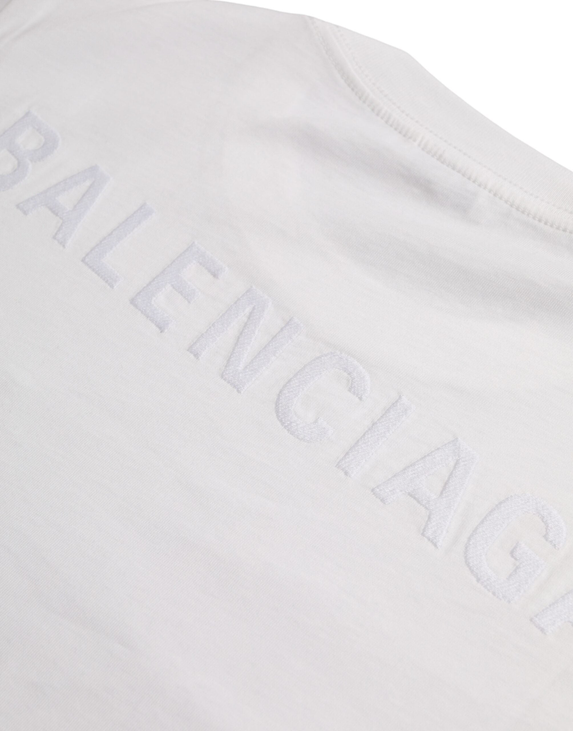 White cotton crew neck short sleeve T-shirt by Balenciaga, showing the plain front design and soft fabric texture.