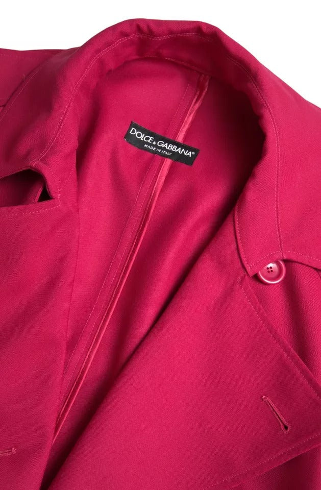 Dark pink Dolce & Gabbana double-breasted trench coat jacket displayed on a model. Stylish, lightweight outerwear with classic design.