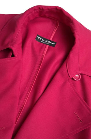 Dark pink Dolce & Gabbana double-breasted trench coat jacket displayed on a model. Stylish, lightweight outerwear with classic design.