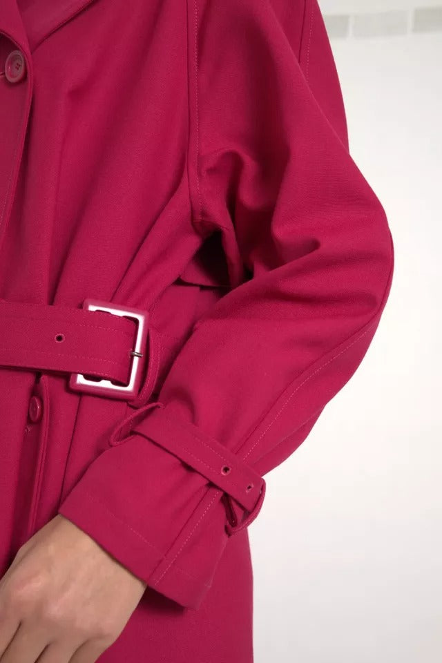 Dark pink double-breasted trench coat jacket by Dolce & Gabbana, shown on a model with classic collar and stylish buttons.