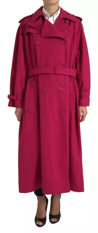 Dark pink Dolce & Gabbana double-breasted trench coat jacket hanging on a wooden hanger, showcasing its stylish design and fabric details.