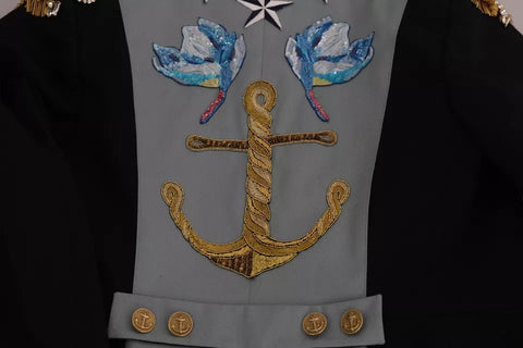 Blue cotton jacket by Dolce & Gabbana with crystal button embellishments and elegant design.