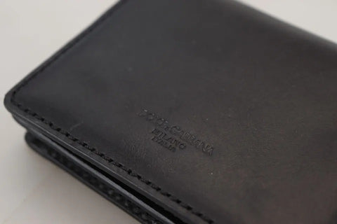 Black leather bifold shoulder sling wallet for women by Dolce & Gabbana, featuring a sleek design and compact size.