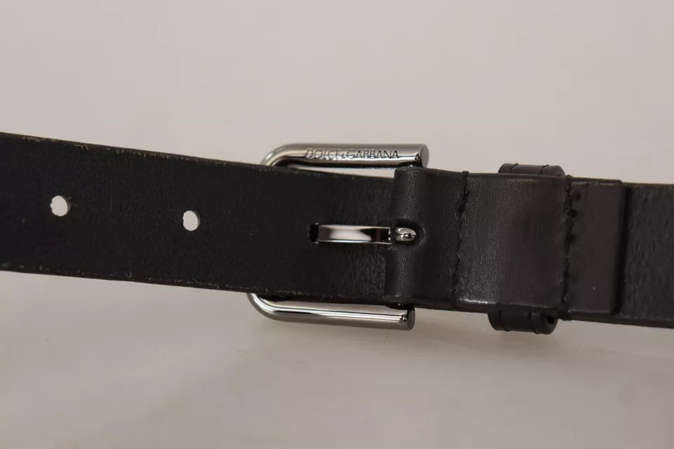Black calf leather belt with a classic metal logo buckle from Dolce & Gabbana, featuring a sleek and stylish design.