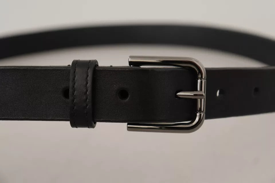 Black calf leather belt with classic metal logo buckle by Dolce & Gabbana, featuring sleek design and smooth finish.