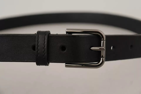 Black calf leather belt with classic metal logo buckle by Dolce & Gabbana, featuring sleek design and smooth finish.
