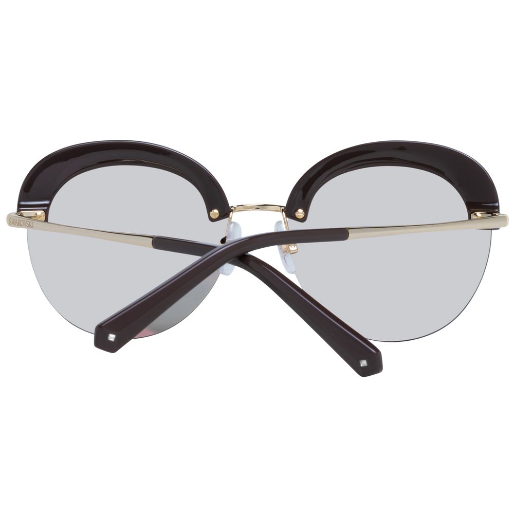 Swarovski gold metal and plastic sunglasses with stylish frame and tinted lenses, fashionable accessory for sunny days