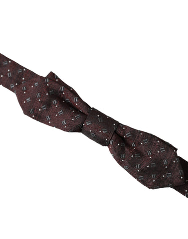 Dolce & Gabbana maroon silk patterned adjustable neck bow tie with papillon style, shown in a close-up image.