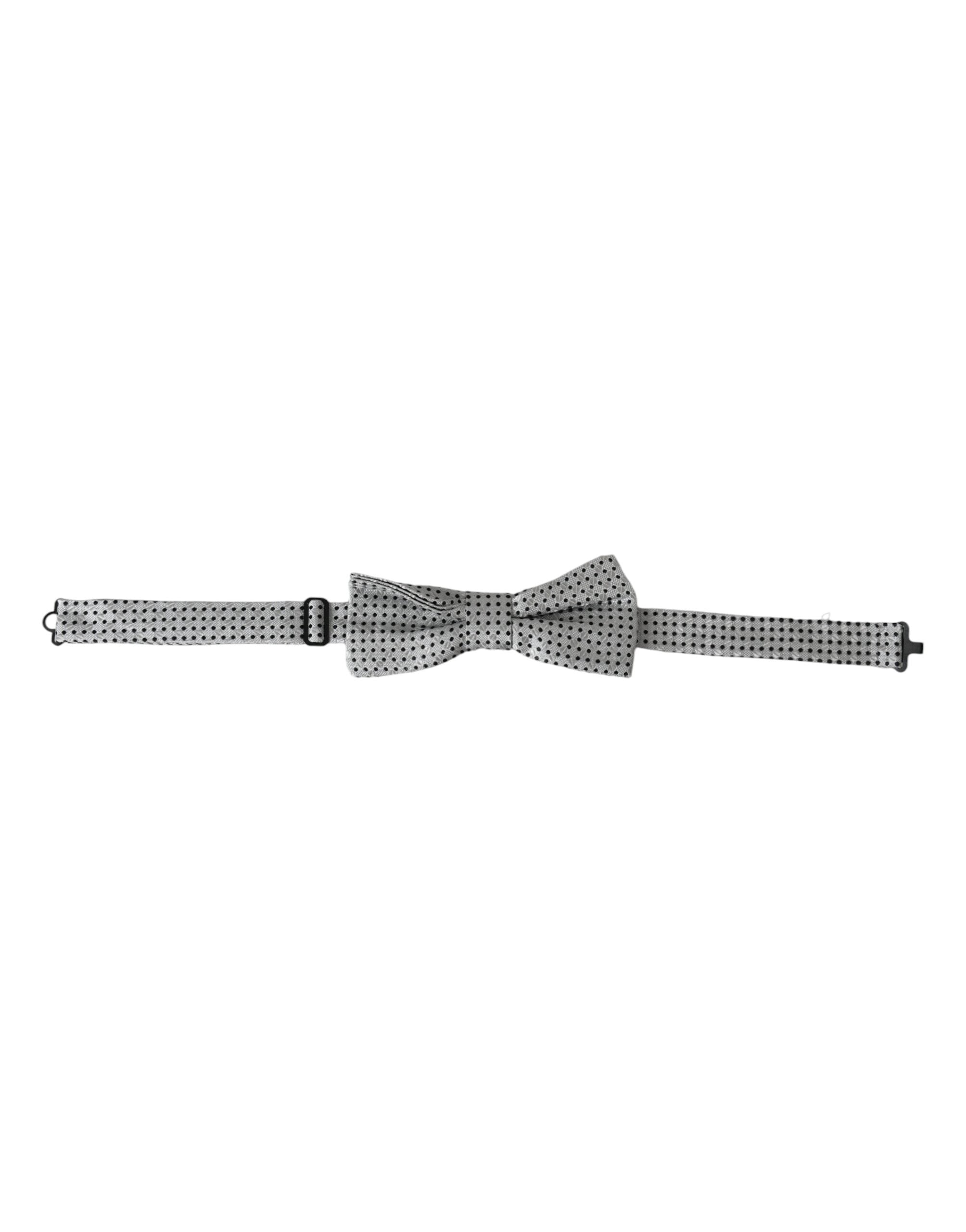 Gray silk polka dot bow tie with adjustable neck strap, men's papillon style by Dolce & Gabbana, shown on a plain background.