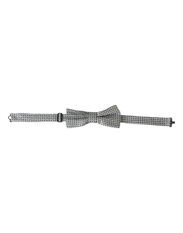 Gray silk polka dot bow tie with adjustable neck strap, men's papillon style by Dolce & Gabbana, shown on a plain background.