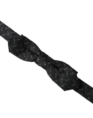 Black silk patterned adjustable neck bow tie for men by Dolce & Gabbana, featuring a stylish papillon design.