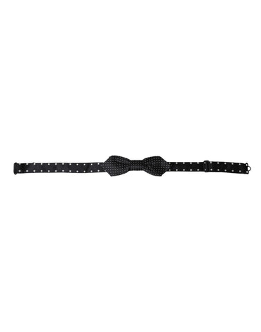 Black silk polka dot adjustable men's bow tie with papillon style, by Dolce & Gabbana, shown on a white background.