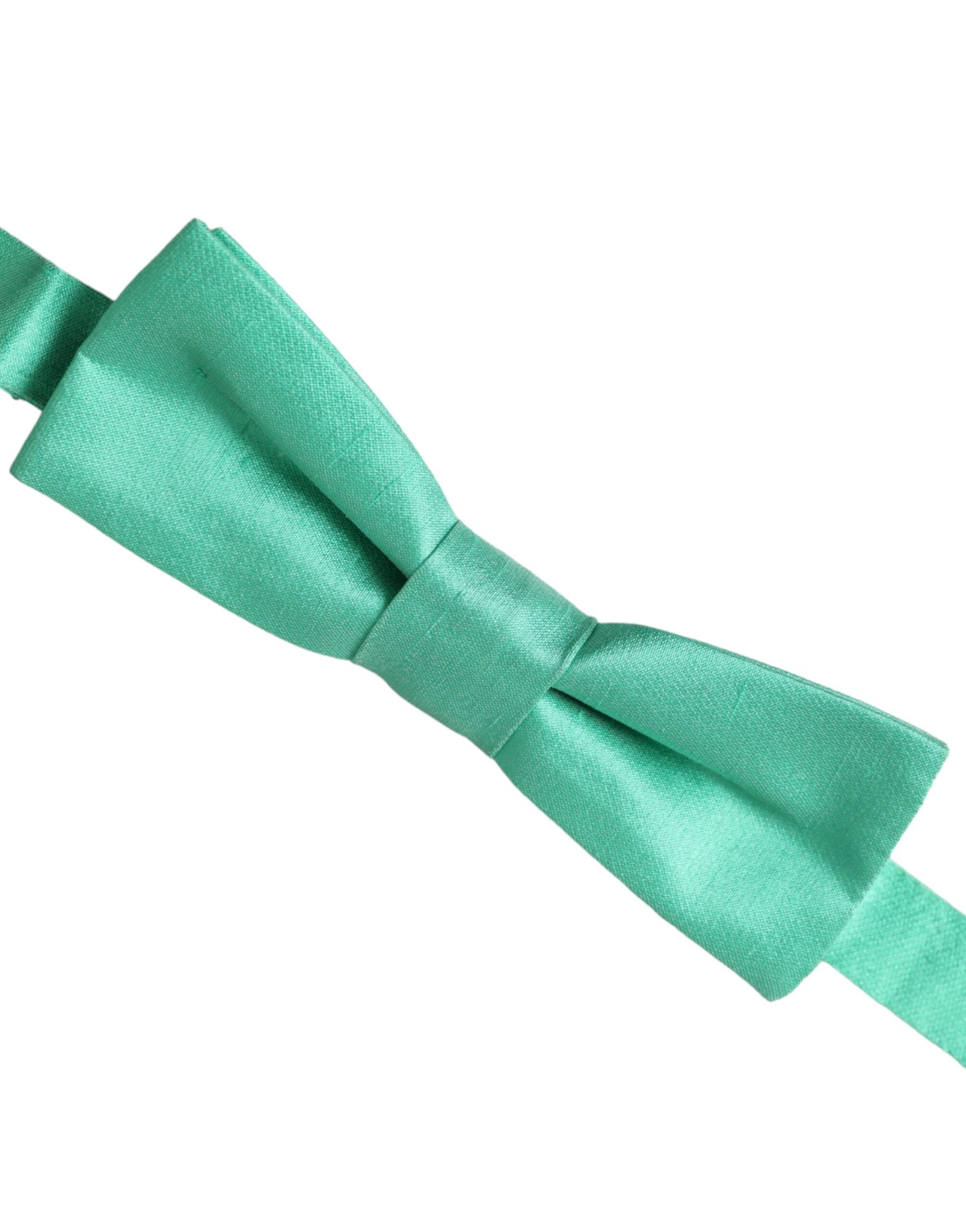 Mint green silk adjustable neck bow tie for men by Dolce & Gabbana, shown laid flat with adjustable strap visible.