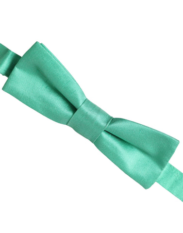 Mint green silk adjustable neck bow tie for men by Dolce & Gabbana, shown laid flat with adjustable strap visible.