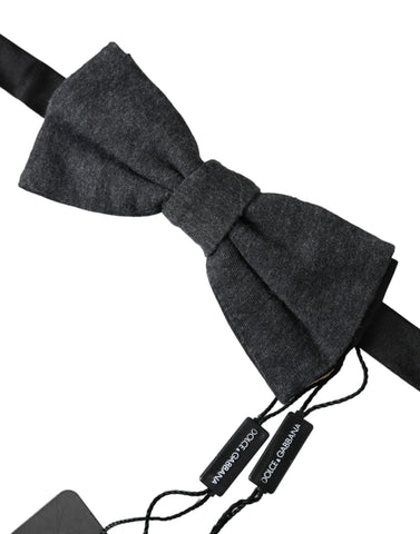 Dark gray silk men's bow tie with adjustable neck strap from Dolce & Gabbana, featuring a sleek, elegant design.