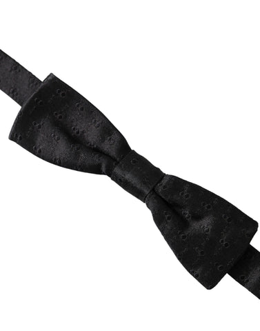Black silk patterned adjustable men's bow tie by Dolce & Gabbana, featuring a stylish design for formal wear.