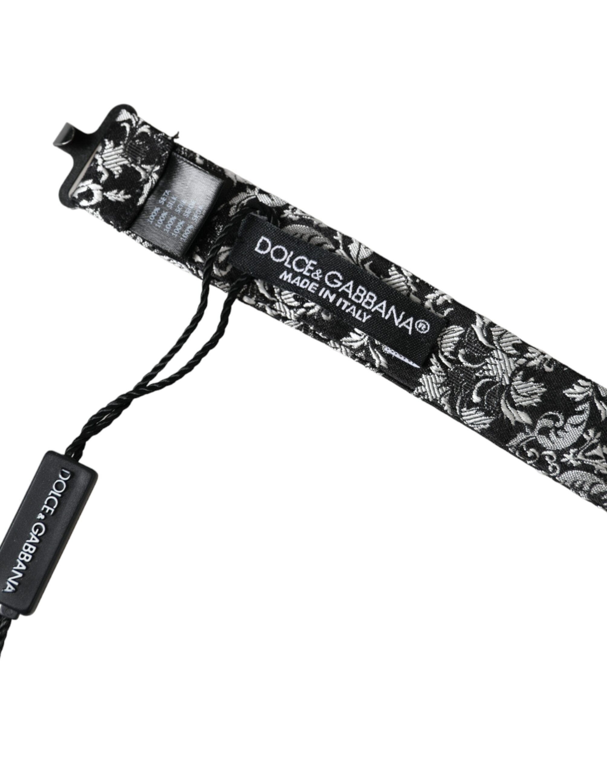Black floral silk men's bow tie with adjustable neck strap by Dolce & Gabbana, featuring a stylish floral pattern.