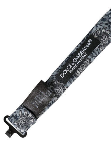Gray silk patterned adjustable men's bow tie by Dolce & Gabbana displayed flat with intricate design details.