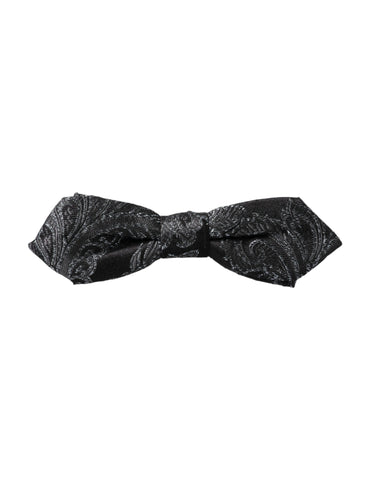 Black silk jacquard men's bow tie with adjustable neck strap by Dolce & Gabbana, featuring intricate woven pattern.
