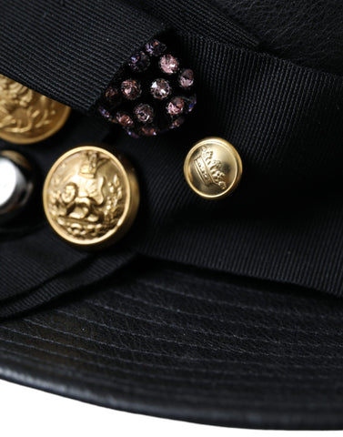 Black leather Dolce & Gabbana wide brim hat with crystal accents and a coin detail, featuring a stylish and luxurious design.