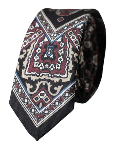 Black printed 100% silk adjustable men's tie by Dolce & Gabbana displayed flat with detailed pattern visible.
