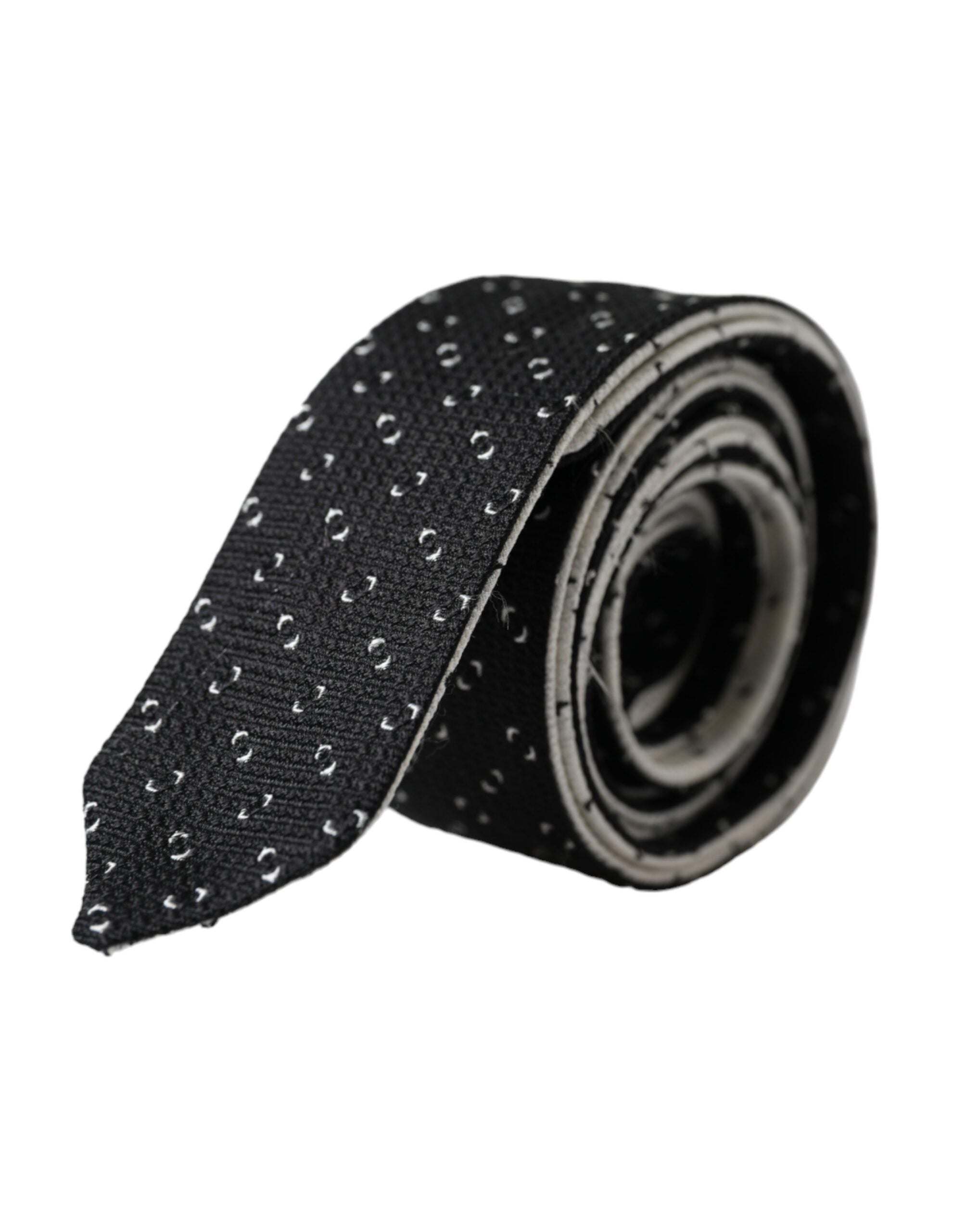 Black and white patterned adjustable tie by Dolce & Gabbana with intricate geometric design on smooth fabric.