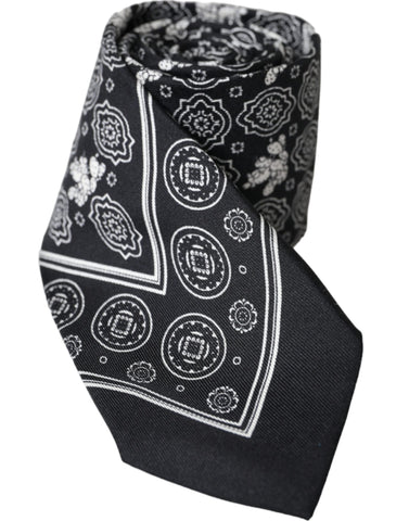Black patterned 100% silk adjustable tie by Dolce & Gabbana, featuring a stylish design and classic knot on a neutral background.